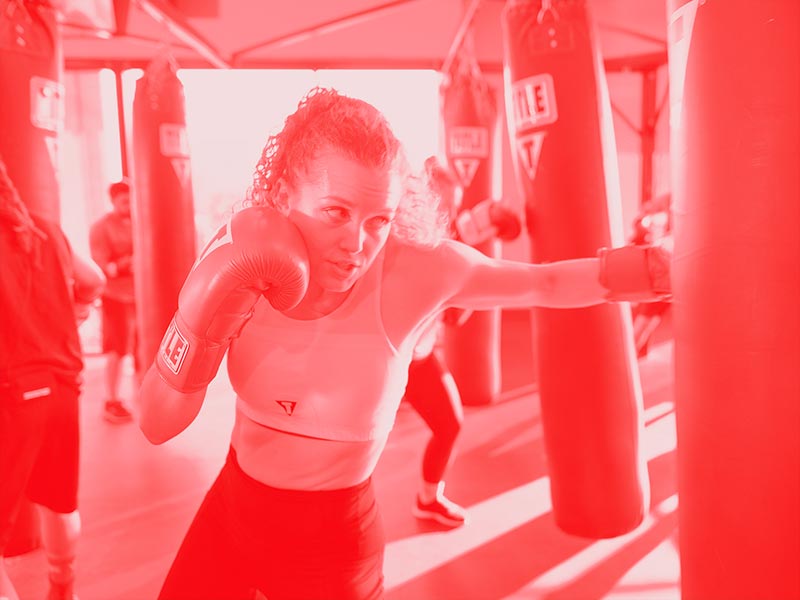 woman hitting weighted bag